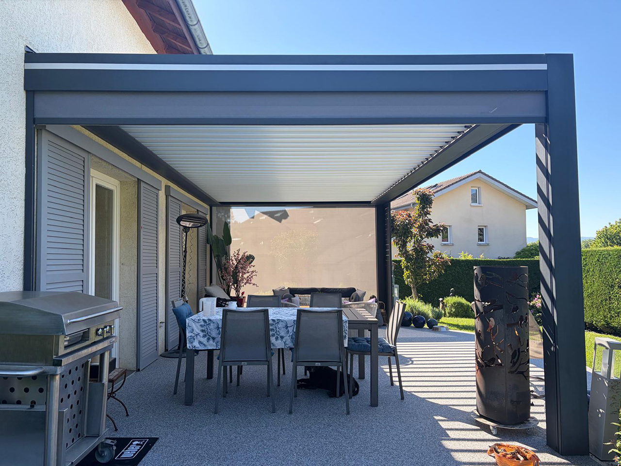 Terrasse couverte par une pergola Sunbox Epure avec brise-vue aluminium